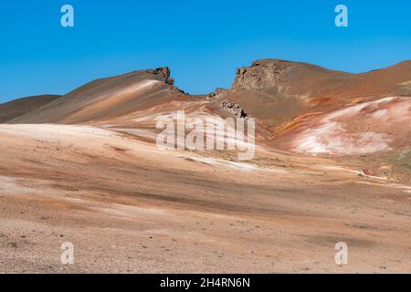 Panoramic view over a barren mountain landscape near Lake Myvatn, Iceland with various colors of the minerals like iron and rhyolite in the rock Stock Photo