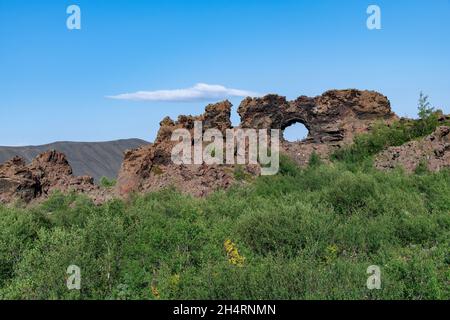Low angle view of the unusually shaped lava fields and rock formations of Dimmuborgir near Lake Myvatn, Icelandare which are badlands of lava pillars, Stock Photo