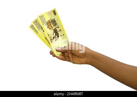 Fair hand holding 3D rendered Congolese franc notes isolated on white background Stock Photo