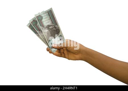 Fair hand holding 3D rendered Egyptian pound notes isolated on white background Stock Photo