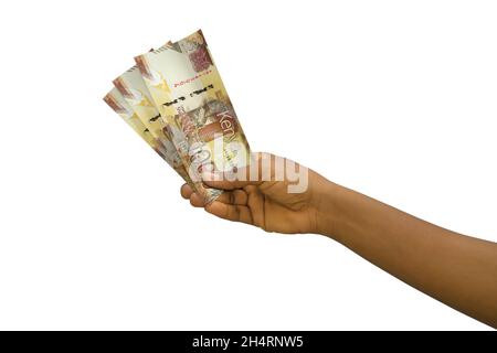 Fair hand holding 3D rendered Kenyan shilling notes isolated on white background Stock Photo