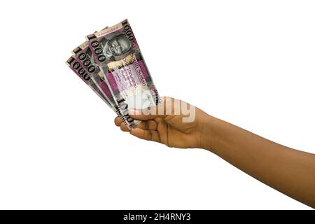 Fair hand holding 3D rendered South Sudanese pound notes isolated on white background Stock Photo
