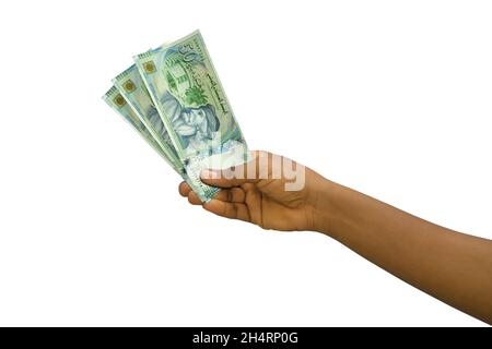 Fair hand holding 3D rendered Tunisian Dinar notes isolated on white background Stock Photo