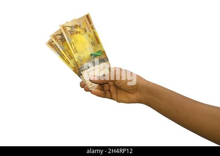 Fair hand holding 3D rendered Ugandan shilling notes isolated on white background Stock Photo