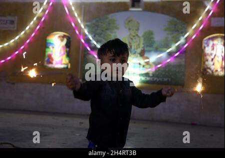 Members of Hindu Community are celebrating Diwali Festival held at Sawami Narain Temple in Karachi on Thursday, November 04, 2021. Pakistani Hindus are celebrating Diwali also known as Deepavali or the festival of lights across the country with zeal and fervour, with families decorating their houses and temples with colourful lights. Stock Photo