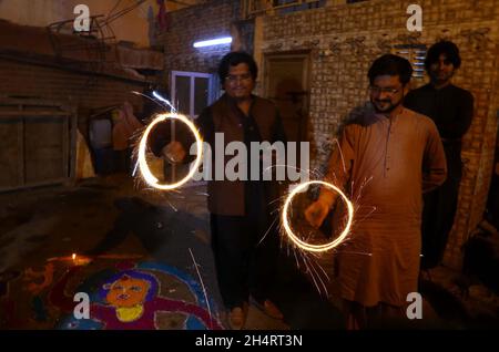 Members of Hindu Community are celebrating Diwali Festival held at Sawami Narain Temple in Karachi on Thursday, November 04, 2021. Pakistani Hindus are celebrating Diwali also known as Deepavali or the festival of lights across the country with zeal and fervour, with families decorating their houses and temples with colourful lights. Stock Photo