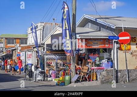 Streetscene showing local black people and shops at St. John's, capital city of Antigua and Barbuda, Lesser Antilles, West Indies in the Caribbean Sea Stock Photo