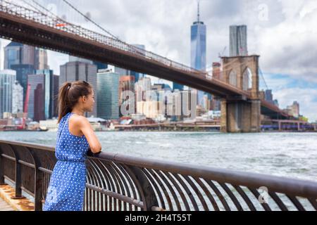 New York city NYC summer travel tourist woman enjoying view of Manhattan skyline from Brooklyn park living a happy lifestyle walking during USA Stock Photo