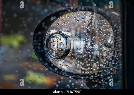 Weather. Rain drops on car window mirror Stock Photo