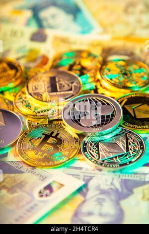 Selection of cryptocurrency coins and British Pound notes with Ripple XRP token coin in focus Stock Photo