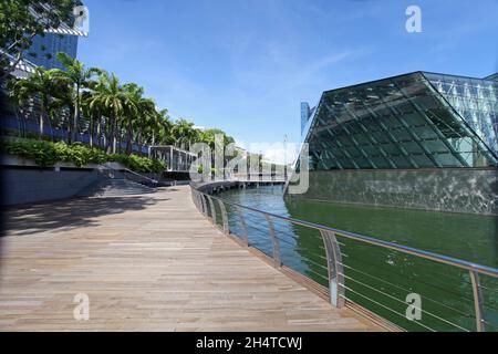 A walk along the water front at Marina Bay Sands with The Shoppes shopping mall on the left and the Louis Vuitton shop on the right in Singapore. Stock Photo