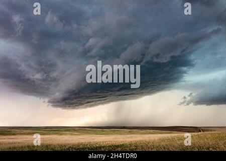 Stormy weather and sky with dark clouds and rain falling near Glendive, Montana, USA Stock Photo