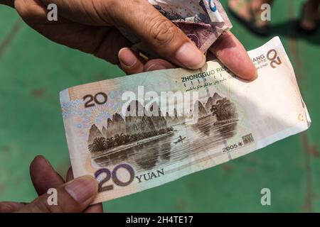 The 20 Yuan banknote has a scene of the Li River with a fisherman on the back side of the bill.  China. Stock Photo