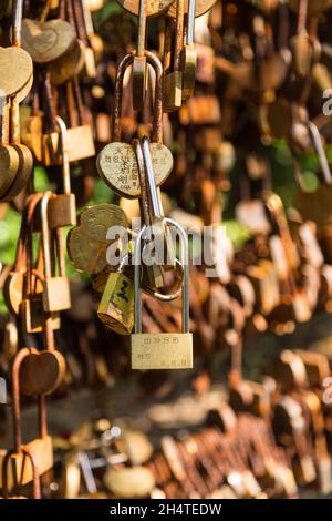 Traditional love locks signifying romantic relationships on bars in Zhangjiajie National Forest Park, Hunan, China. Stock Photo