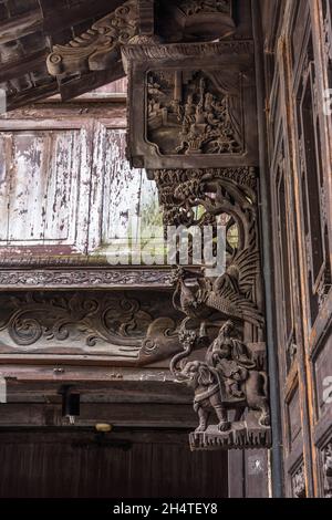 Elaborate wood carving of a phoenix & people in tradtional dress on an old building in Wuzhen, China. Stock Photo