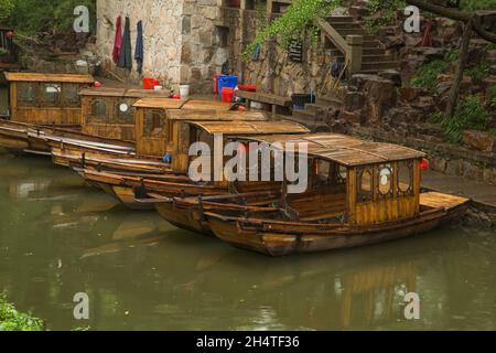 Covered wooden tour boats moored on the moat around the Tiger Hill in Suzhou, China. Stock Photo