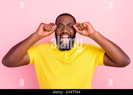 Photo of amazed shocked scared afro american man wear glasses bad mood isolated on pastel pink color background Stock Photo