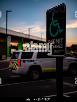 CALGARY, CANADA - Oct 06, 2021: A vertical shot of Alberta Health EMS vehicle parked near handicap parking stall Stock Photo