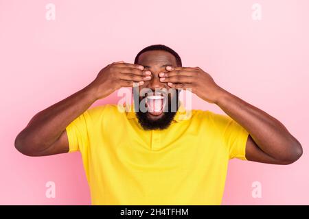 Portrait of attractive funky cheerful guy closing eyes having fun isolated over pink pastel color background Stock Photo