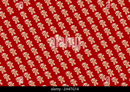 New Year concept. Trendy pattern made with Christmas gingerbread man on bright light red background. Minimal creative concept. Creative Christmas deco Stock Photo