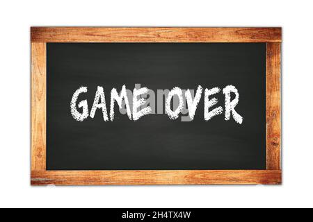 GAME  OVER text written on black wooden frame school blackboard. Stock Photo