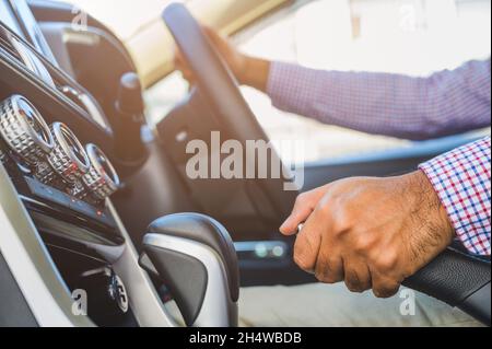 Close up hand push up car handbrake. Safety drive concept. Stock Photo