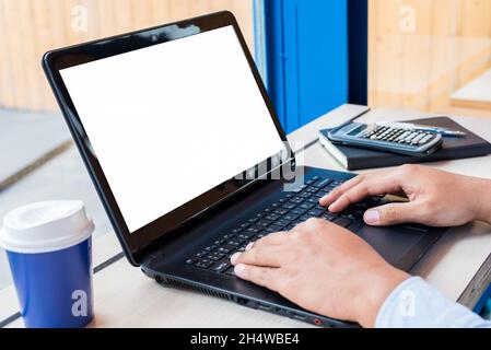 Close up male hands texting with his laptop.Office desk & blank space on laptop. Stock Photo