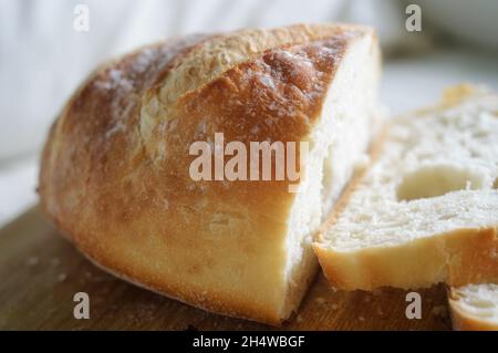 Loaf of sourdough bread with two slices cut Stock Photo
