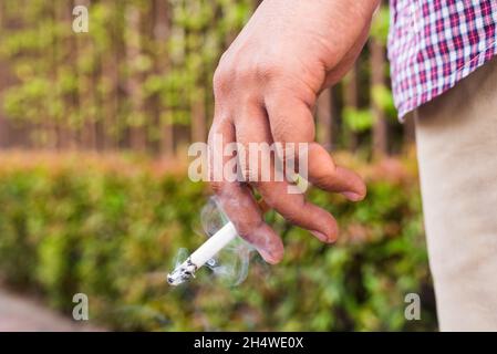 Young man Smoking cigarette.Man holding cigarette. Stock Photo