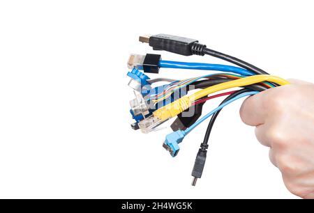 Bunch of computer cables in women's hand isolated on white background. Bundle of computer interface cables with different connectors Stock Photo