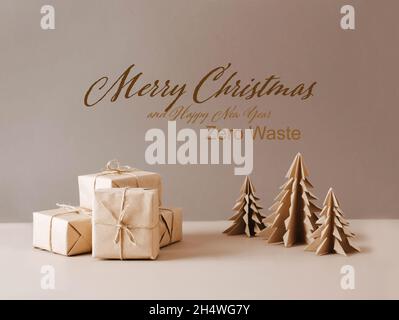 Christmas tree made of paper craft origami gifts packed in plain paper wooden star on a beige trendy background. Stock Photo