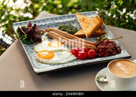 Served english breakfast with cappuccino coffee Stock Photo