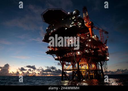 Natural Gas Rig, before sunrise, Hai Feng 19 Oilfield, South China Sea off the Chinese coast, China  2 Sept 2021 Stock Photo