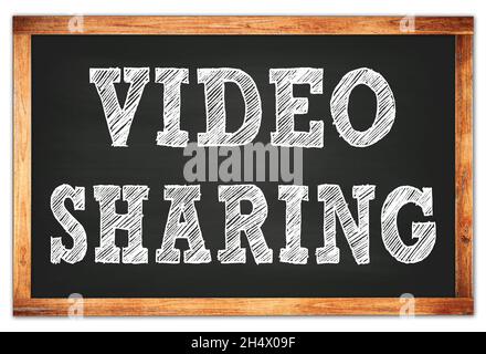 VIDEO SHARING written on black wooden frame school blackboard Stock Photo