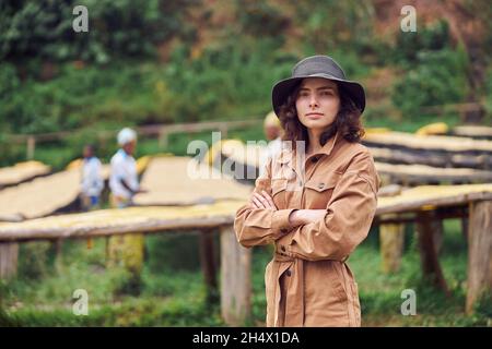 caucasian woman is standing in front of coffee washing station in eastern africa region Stock Photo