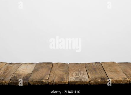Empty wooden table top from rustic old wood planks, neutral gray background. Stock Photo