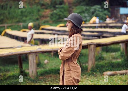 caucasian woman is standing in front of coffee washing station in eastern africa region Stock Photo