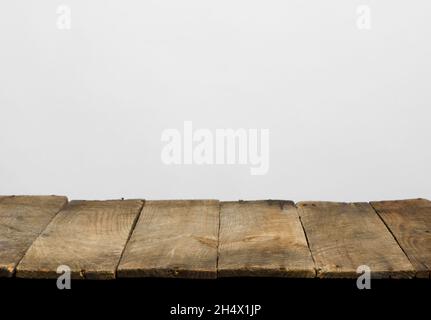 Empty wooden table top from rustic old wood planks, neutral gray background. Stock Photo