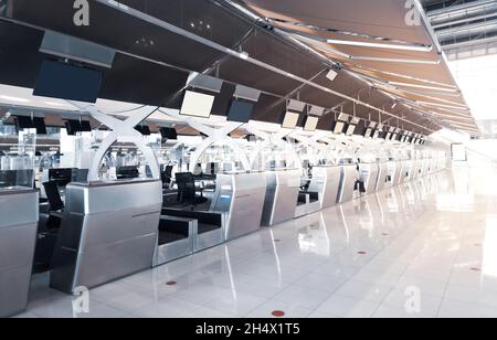 Empty airline check-in counter at airport due to Covid-19 travel restrictions. Stock Photo