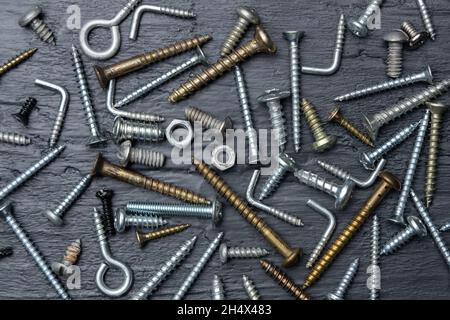 Construction screws and nuts on a black background Stock Photo