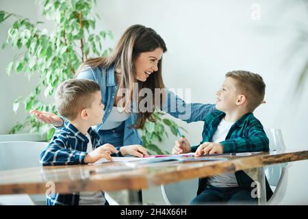 homework teaching education mother children son familiy childhood Stock Photo