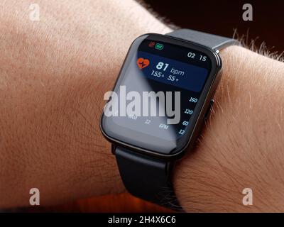 closeup man checking health smart watch or smartwatch wearable technology sport smartwatch on fitness Stock Photo