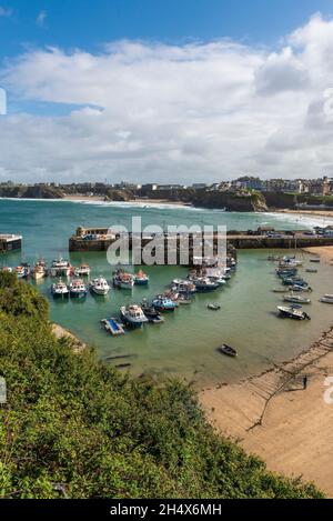 Fishing boats moored in the picturesque working harbour in Newquay in Cornwall. Stock Photo