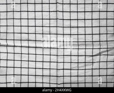 Checkered tablecloth fabric or towel. Black with white square pattern as background Stock Photo