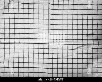 Checkered tablecloth fabric or towel. Black with white square pattern as background Stock Photo