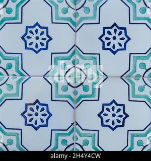Fragment of building wall. Vintage ceramic wall tiles, Azulejos, close up. Abstract decorative background. Traditional ornate Portuguese architecture. Stock Photo