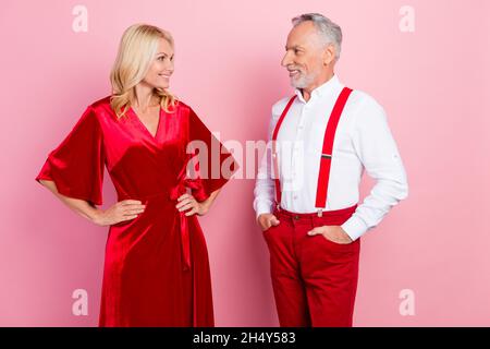 Portrait of two beautiful handsome cheerful spouses meeting dating festal time occasion isolated over pink pastel color background. Stock Photo