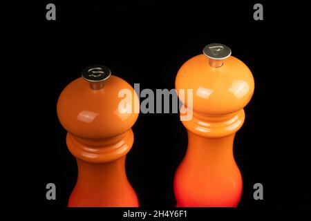 Close up of salt and pepper mills and grinders isolated on a black background. Stock Photo