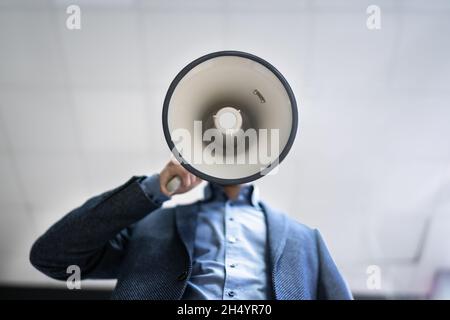 Megaphone Attention Concept. Man Shouting Using Loudspeaker Stock Photo