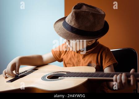 kid plays guitar Stock Photo